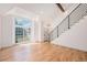 Open-concept living area with hardwood floors, lots of light, and modern staircase at 9948 King St, Westminster, CO 80031