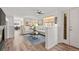 Open-concept living room with hardwood floors, neutral decor, fireplace, and seamless flow into the dining area at 13739 Legend Trl # 102, Broomfield, CO 80023
