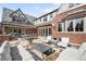 Spacious backyard patio featuring stone pavers, lounge chairs, and outdoor dining at 2020 E 4Th Ave, Denver, CO 80206