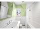 Bright bathroom featuring a bathtub/shower and charming green walls at 2020 E 4Th Ave, Denver, CO 80206