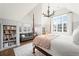 Bright bedroom featuring a four poster bed, sitting area, and built-in bookshelves at 2020 E 4Th Ave, Denver, CO 80206