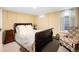 Cozy bedroom with a dark wood bed frame, soft carpet, and a side table with lamp at 2020 E 4Th Ave, Denver, CO 80206