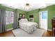 Charming bedroom with an ample bed, herringbone rug, and green walls at 2020 E 4Th Ave, Denver, CO 80206