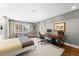 Bright bedroom with a wooden desk and a chair, next to a large window, and hardwood floors at 2020 E 4Th Ave, Denver, CO 80206