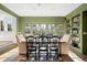 Elegant dining room featuring green walls, natural lighting, and a stylish area rug at 2020 E 4Th Ave, Denver, CO 80206