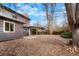 Large backyard with a covered patio, concrete area, and rock landscape at 4682 Chatham St, Boulder, CO 80301