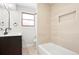 Modern bathroom featuring a vanity, bathtub, and tiled shower with a niche at 4682 Chatham St, Boulder, CO 80301