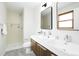 Modern bathroom featuring double sinks, tiled shower, and neutral color palette at 4682 Chatham St, Boulder, CO 80301