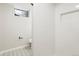 Bright bathroom showcases a tiled shower with a niche, gray patterned floor, and a modern toilet at 4682 Chatham St, Boulder, CO 80301