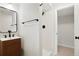 Modern bathroom features stylish wood vanity, sleek black fixtures, and a tiled shower with a glass door at 4682 Chatham St, Boulder, CO 80301