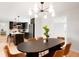 Dining room with an oval table and modern lighting fixture, connecting seamlessly to the open-concept kitchen at 4682 Chatham St, Boulder, CO 80301
