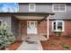 Charming front entrance features a brick facade, covered porch, and well-manicured landscaping at 4682 Chatham St, Boulder, CO 80301