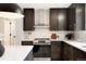 This kitchen features stainless steel appliances, dark cabinets, and a marble backsplash for a clean design at 4682 Chatham St, Boulder, CO 80301