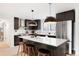 Modern kitchen with stainless steel appliances, an island with bar seating and unique pendant lighting at 4682 Chatham St, Boulder, CO 80301