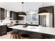 Bright kitchen with modern pendant lighting, an island, and stainless steel appliances at 4682 Chatham St, Boulder, CO 80301