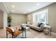 Bright living room with hardwood floors, a bay window, modern furnishings, and a decorative accent wall at 4682 Chatham St, Boulder, CO 80301
