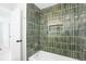 Modern bathroom featuring a tub and a luxurious shower with green tile at 4682 Chatham St, Boulder, CO 80301