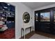 Bright foyer with large mirror, console table, dark trim, and view into living room at 230 Jasmine St, Denver, CO 80220