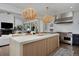 Bright open kitchen features a large island, Wolf range, and stylish woven pendant lighting at 230 Jasmine St, Denver, CO 80220