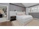 Spacious bedroom with hardwood floors, neutral decor, and a stylish upholstered headboard at 230 Jasmine St, Denver, CO 80220