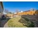 Expansive backyard with a retaining wall, patio with dining set, a well-maintained lawn, and a privacy fence at 8893 W Ontario Ave, Littleton, CO 80128