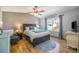 Stylish bedroom with hardwood floors, vaulted ceiling, and large window, creating a comfortable and inviting space at 8893 W Ontario Ave, Littleton, CO 80128