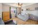 Bright bedroom featuring hardwood floors, a plush daybed, and ample natural light from the large window at 8893 W Ontario Ave, Littleton, CO 80128