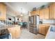 Kitchen features stainless steel appliances, wood cabinets, and an open layout at 8893 W Ontario Ave, Littleton, CO 80128
