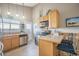 Eat-in kitchen features stainless steel appliances, breakfast bar, and bright natural light at 8893 W Ontario Ave, Littleton, CO 80128