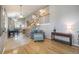 Open-concept living space with hardwood floors and a staircase leading to the upper level at 8893 W Ontario Ave, Littleton, CO 80128