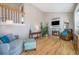 Inviting living room boasts a cozy fireplace, vaulted ceiling, and plenty of natural light at 8893 W Ontario Ave, Littleton, CO 80128