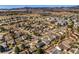 Aerial view of the residential neighborhood with mature trees, green spaces, and mountain views at 8893 W Ontario Ave, Littleton, CO 80128