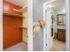 Spacious walk-in closet with built-in shelving and easy access to the bathroom at 8893 W Ontario Ave, Littleton, CO 80128
