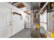 Basement utilities area with white door, including a furnace, water heater, and laundry hookups at 4070 E 119Th Pl # B, Thornton, CO 80233