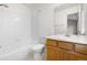 Full bathroom featuring a shower and tub combination with tiled walls and a wooden vanity at 4070 E 119Th Pl # B, Thornton, CO 80233