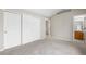 Bedroom featuring carpet, neutral walls, closet doors, and a doorway into a bathroom at 4070 E 119Th Pl # B, Thornton, CO 80233