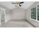 Spacious bedroom with neutral walls, a ceiling fan, and a large window providing ample natural light at 4070 E 119Th Pl # B, Thornton, CO 80233
