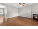 Spacious living room with hardwood floors, fireplace, and a ceiling fan at 4070 E 119Th Pl # B, Thornton, CO 80233