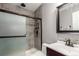 Bathroom with updated shower featuring glass sliding door, tiled walls, and neutral color palette at 8360 W 87Th Dr # D, Arvada, CO 80005