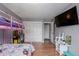 Bedroom featuring a bunk bed, TV, closet and neutral paint at 8360 W 87Th Dr # D, Arvada, CO 80005