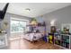 Bright bedroom with large window, pink bunk beds, and light wood flooring at 8360 W 87Th Dr # D, Arvada, CO 80005