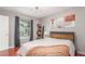 Comfortable bedroom with large window, wood floors, and natural light at 8360 W 87Th Dr # D, Arvada, CO 80005