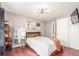 Calm bedroom with a modern chandelier, decorative shelving, and an oversized sliding closet at 8360 W 87Th Dr # D, Arvada, CO 80005