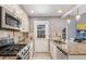 Galley kitchen features stainless appliances, granite countertops, and access to the home's backyard at 8360 W 87Th Dr # D, Arvada, CO 80005