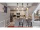 Open concept kitchen with granite countertops, stainless steel appliances, and bar seating for two at 8360 W 87Th Dr # D, Arvada, CO 80005