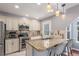 Bright kitchen with stainless steel appliances, granite countertops and breakfast bar seating for two at 8360 W 87Th Dr # D, Arvada, CO 80005