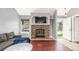 Cozy living room with fireplace and large window offering views of the home's front yard at 8360 W 87Th Dr # D, Arvada, CO 80005