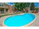 Community swimming pool surrounded by lounge chairs, trees, and fencing at 8360 W 87Th Dr # D, Arvada, CO 80005