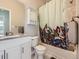 Inviting bathroom with white vanity and tub/shower combo featuring a decorative leaf shower curtain at 9363 Amison Cir # 106, Parker, CO 80134