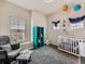 Charming bedroom featuring soft gray carpet, a bright window, and a fun bookshelf at 9363 Amison Cir # 106, Parker, CO 80134